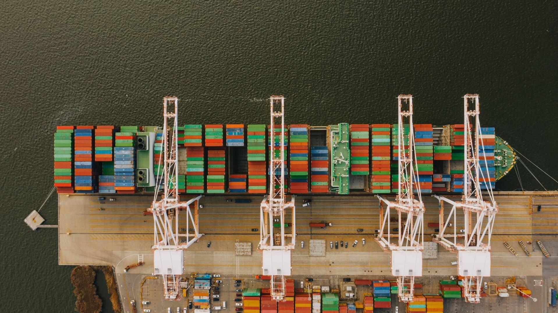 aerial view of container ship full of containers by port side
