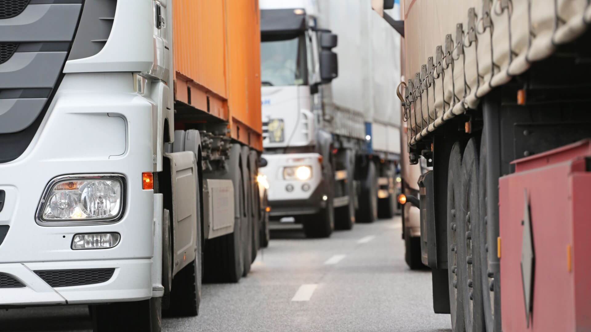 queue of trucks along road