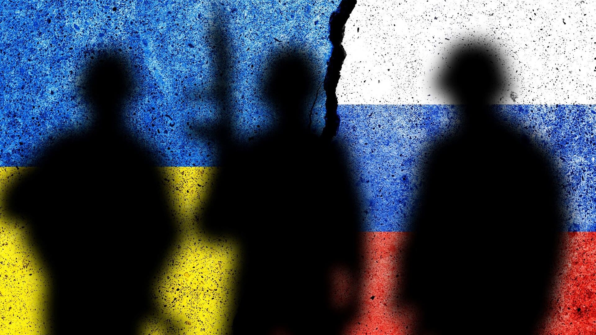 graphic representation of Ukraine flag to left and Russian flag to right, with three shadow outlines of soldiers overlaid on top
