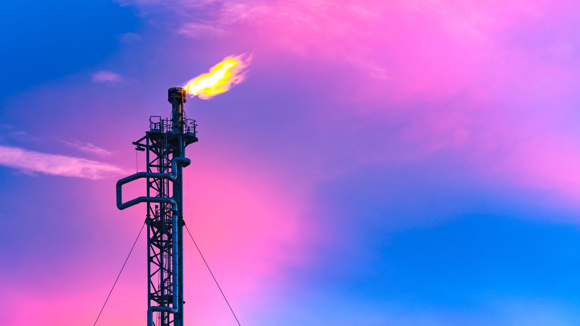 Gas flare against a pink sky