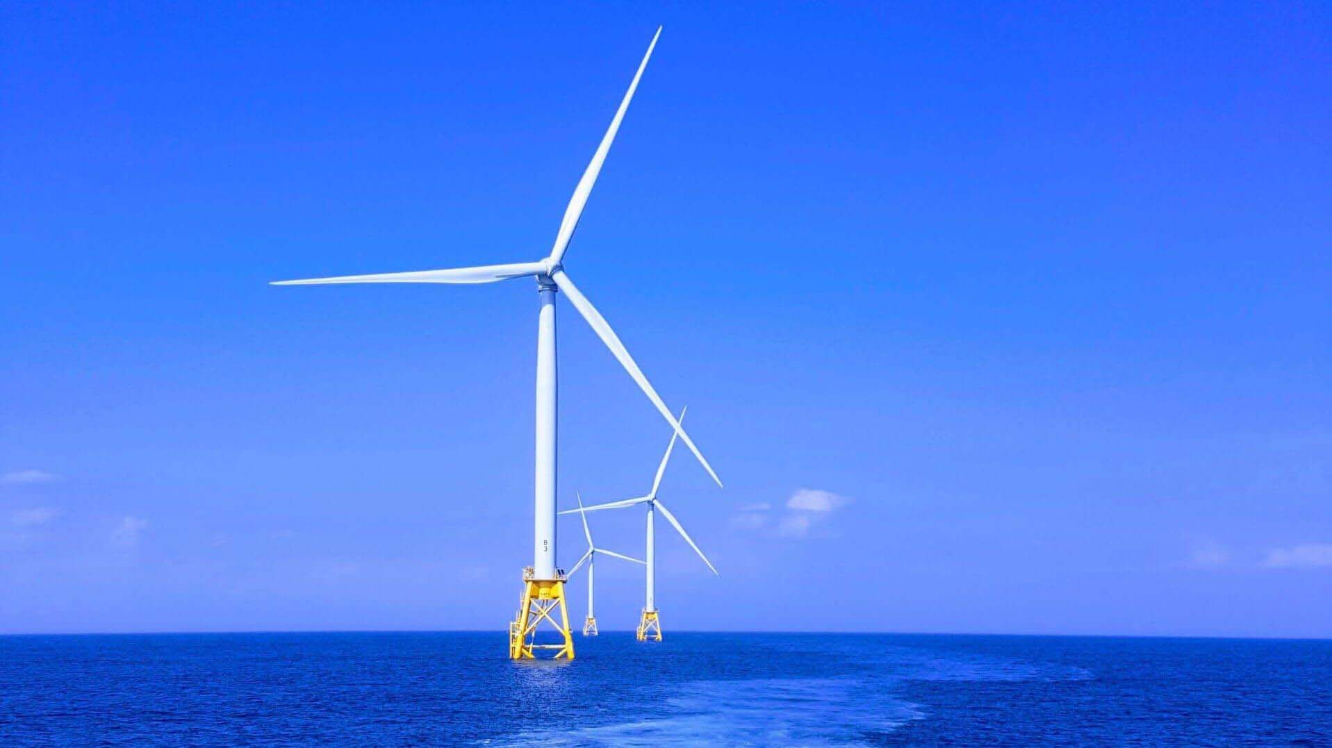 Offshore wind farm in blue sea with blue sky above