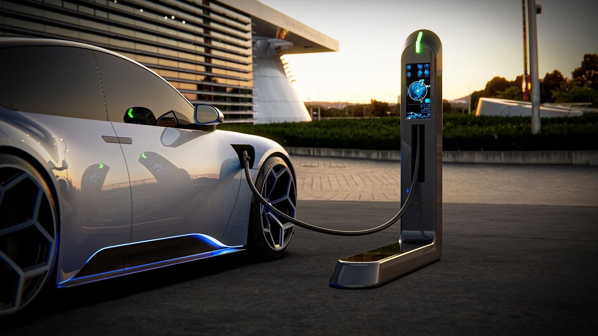 Electric vehicle charging at sunset