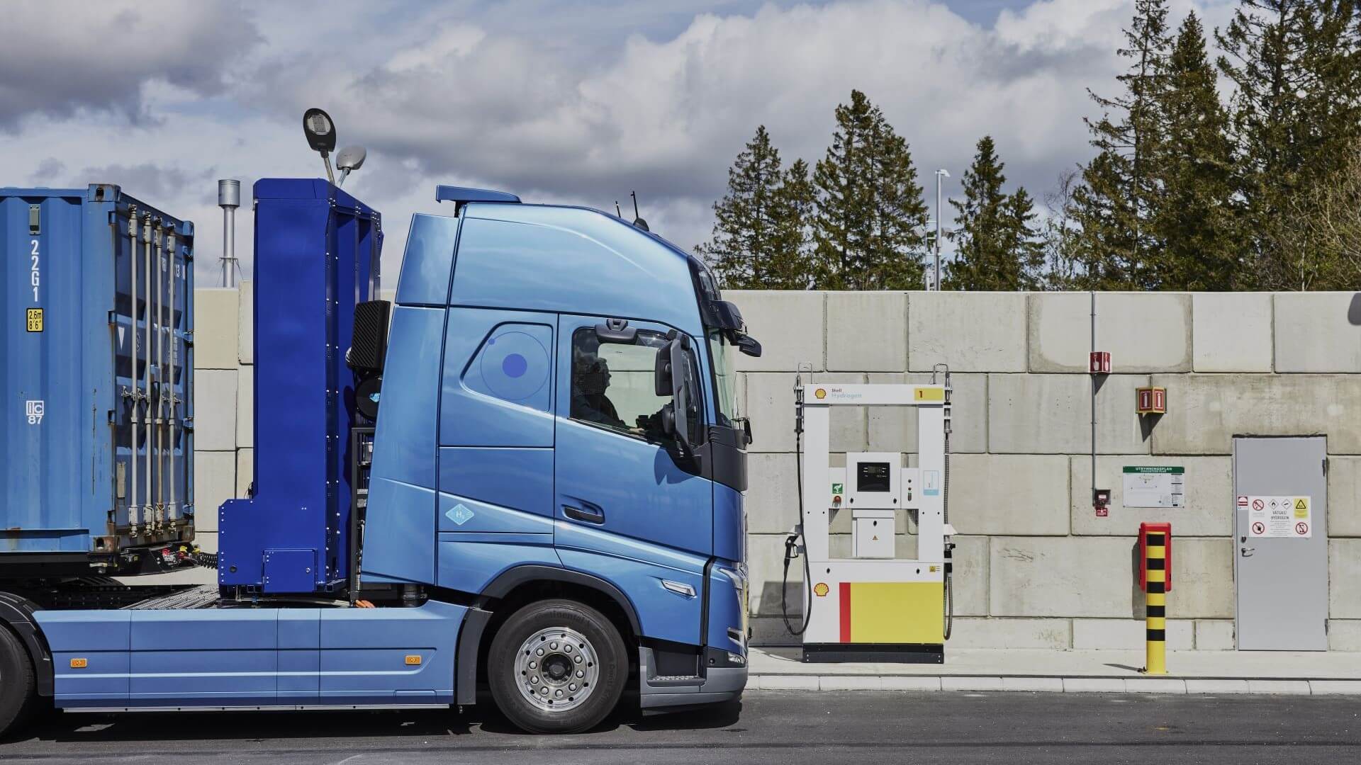 Hydrogen-powered fuel cell electric truck at fuelling station