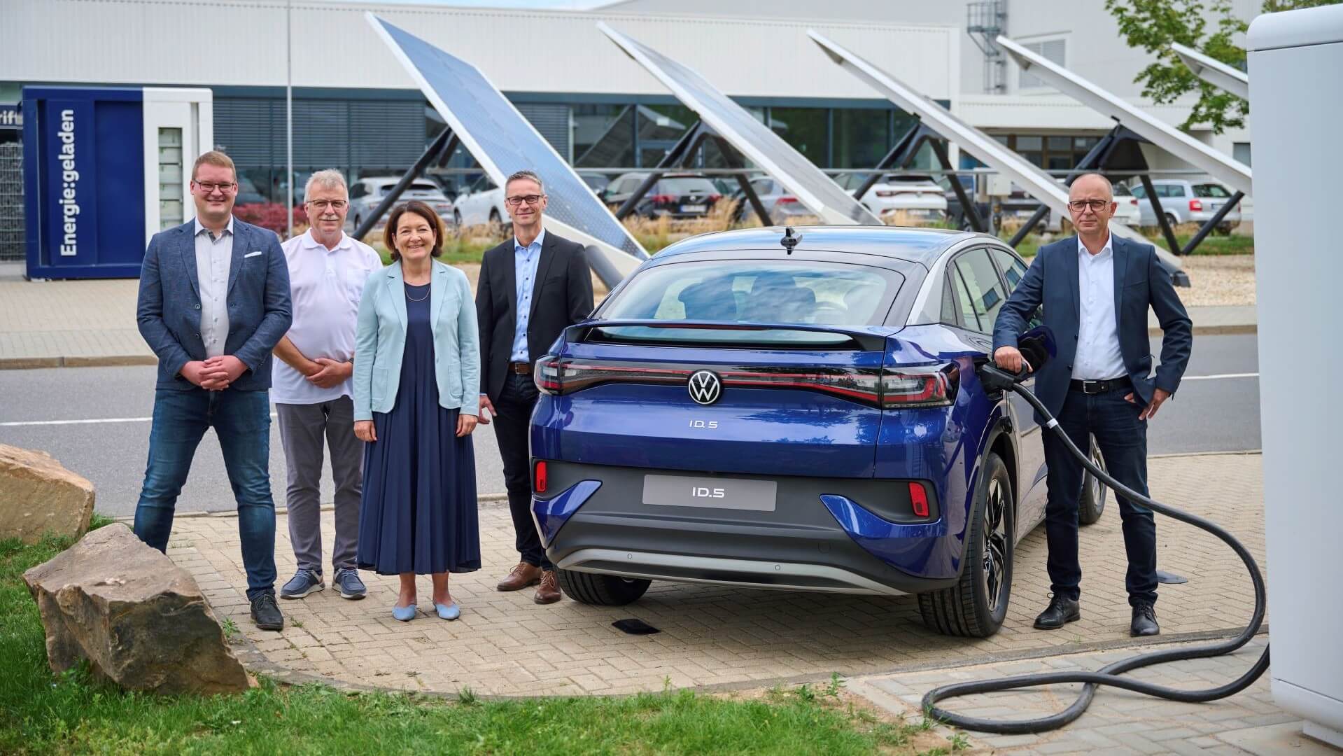 Volkswagen Executives with EV at charging park