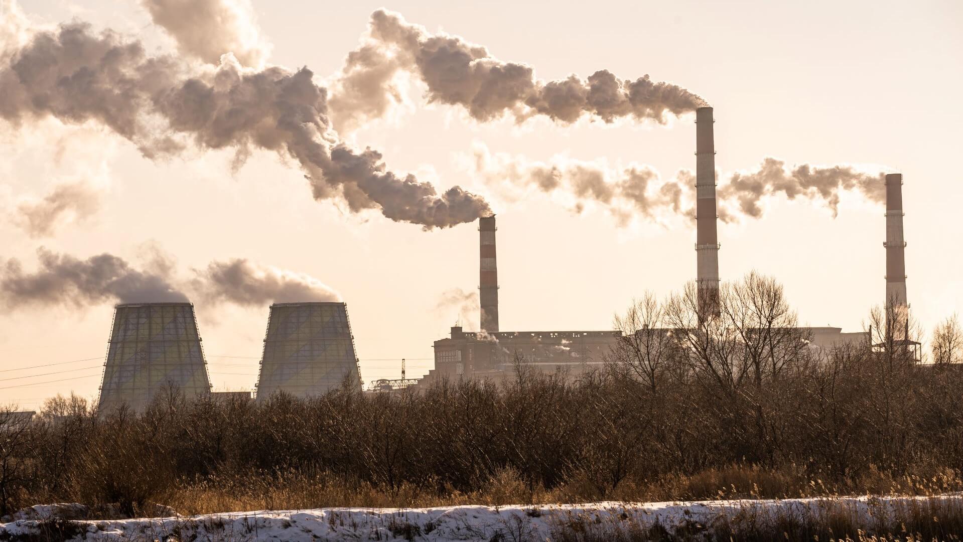 Stark image of coal plant chimney stacks