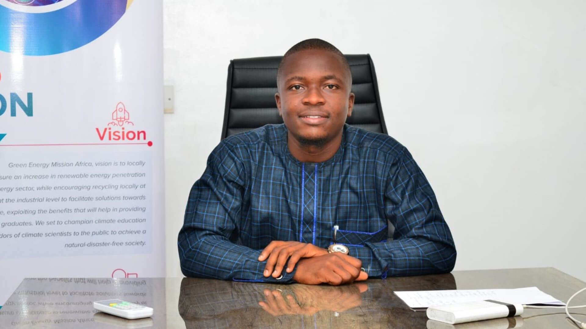 Head and shoulders picture of Promise Nwogu sitting behind desk