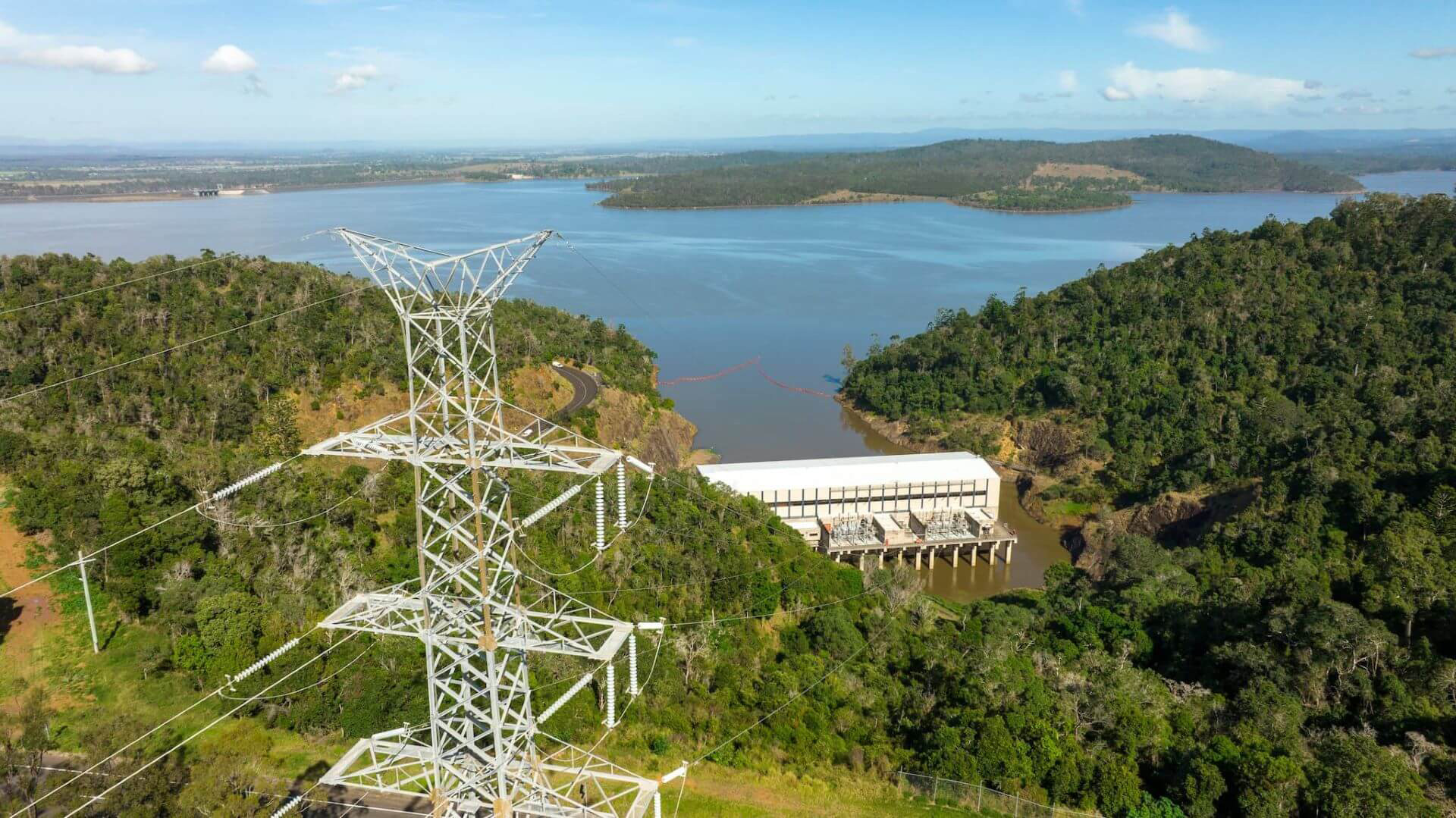 Aerial view of Wivenhoe Dam and electricity pylon