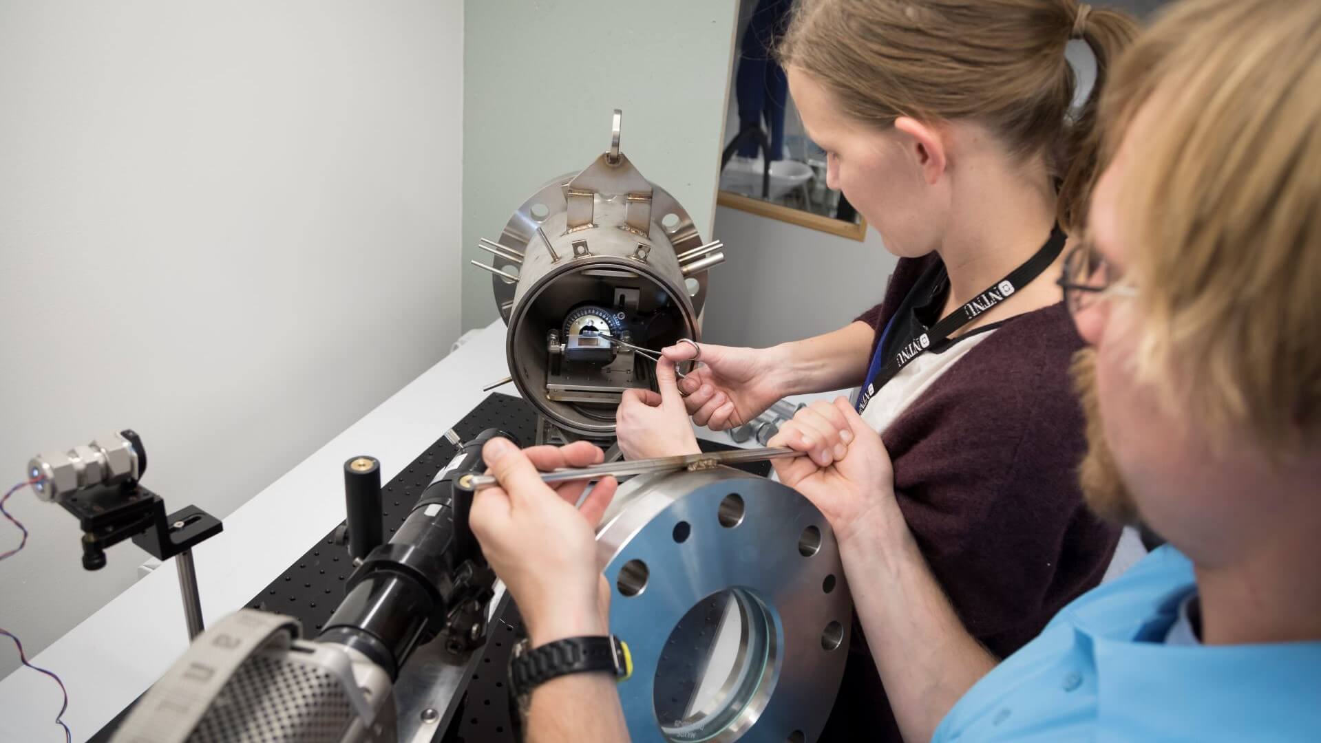 Lab technicians working with equipment studying CO2 condensation at high pressure and low temperature