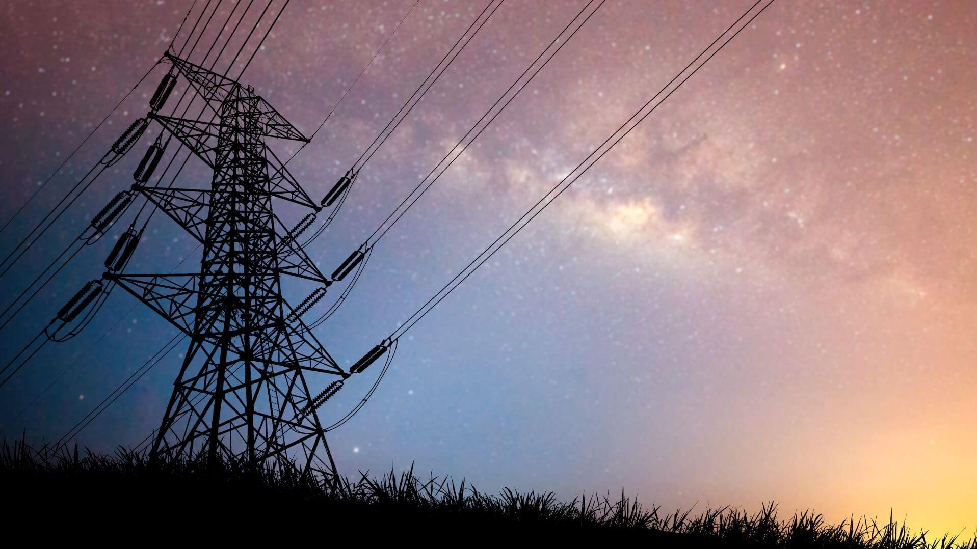 Silhouette of pylon against a darkening sky