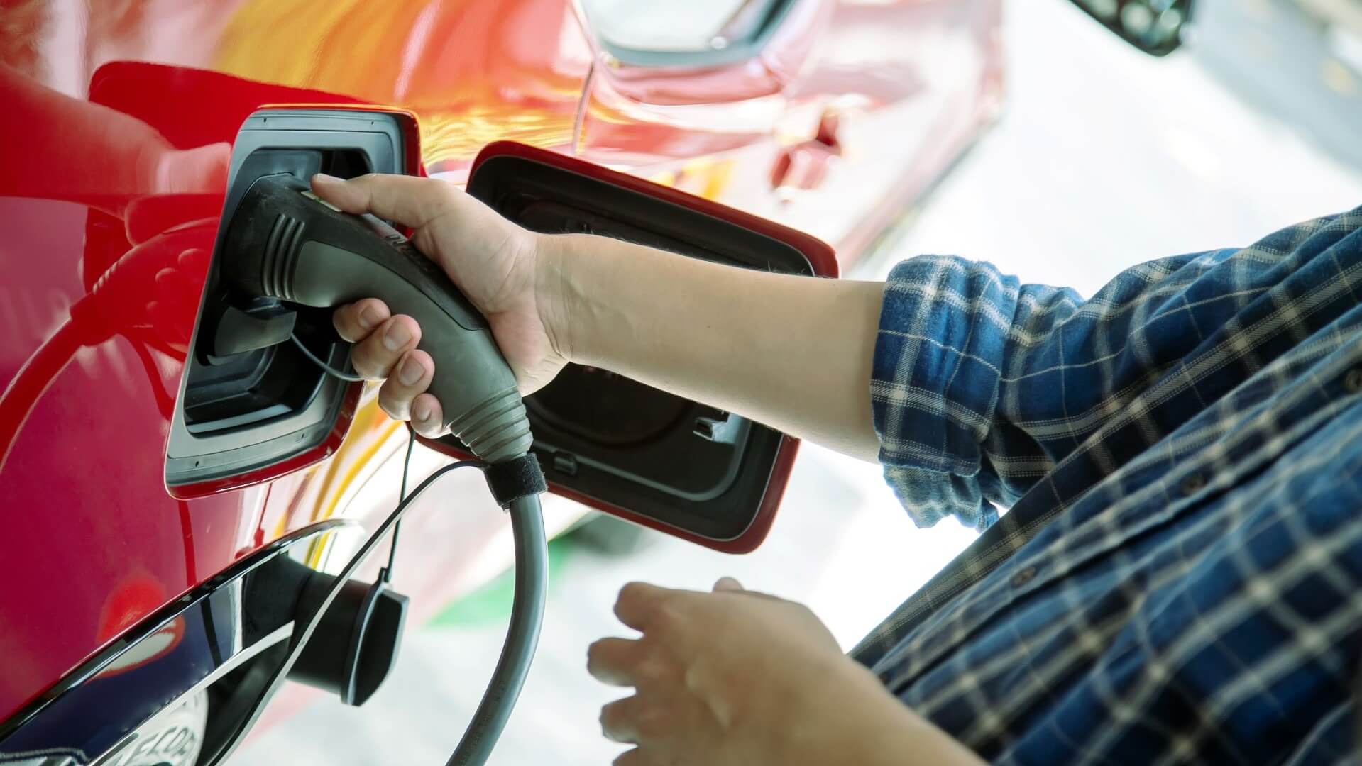 A person charging an EV
