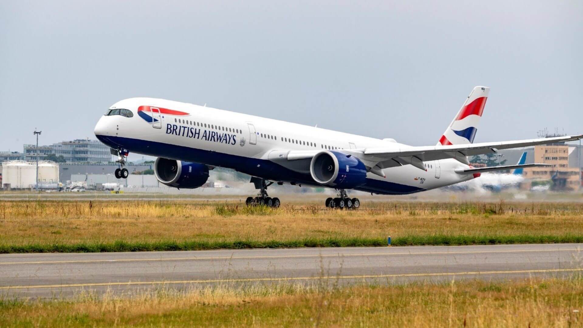 BA flight taking off, with airport in background