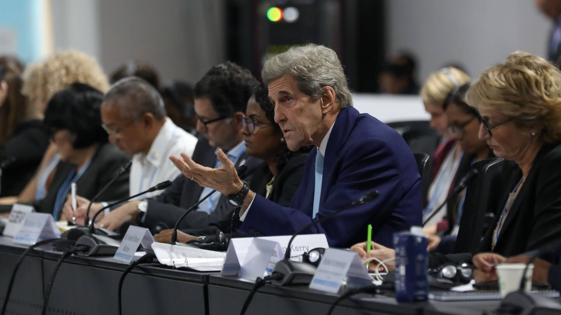 John Kerry seated in row of delegates during COP27