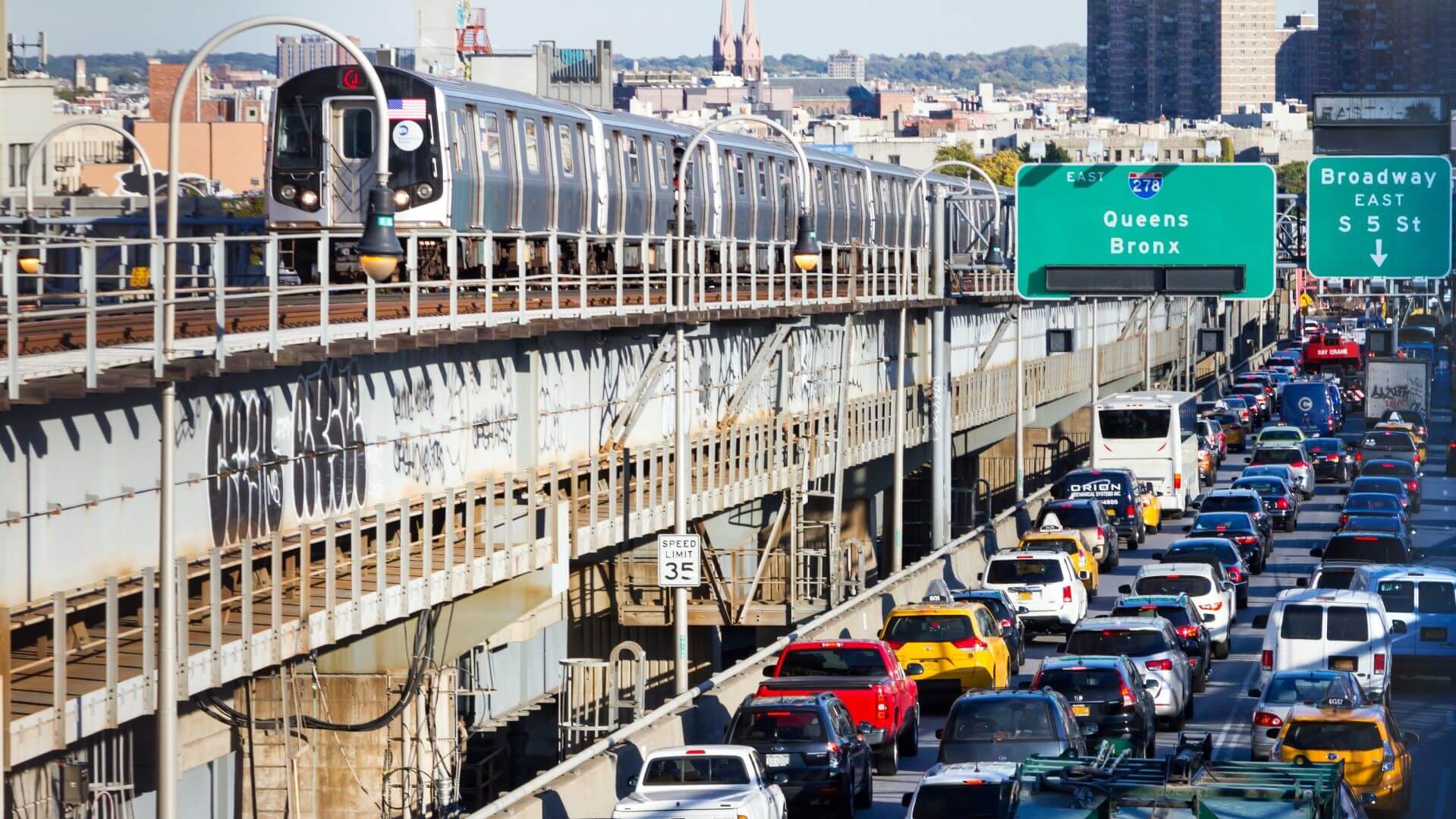 Busy traffic near train line in New York City