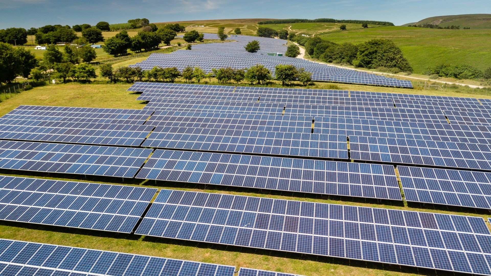 Rows upon row of solar panels set in green countryside
