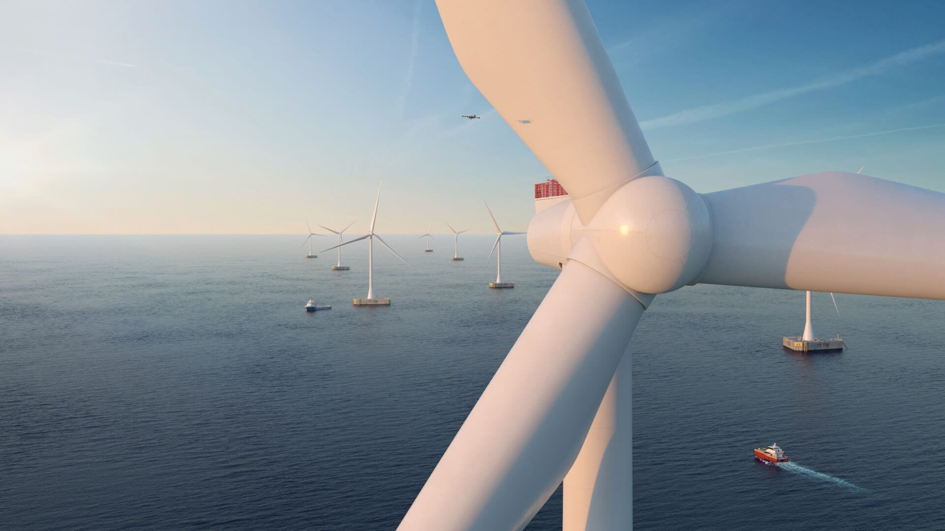 Close up of offshore wind turbine with sea and other turbines behind