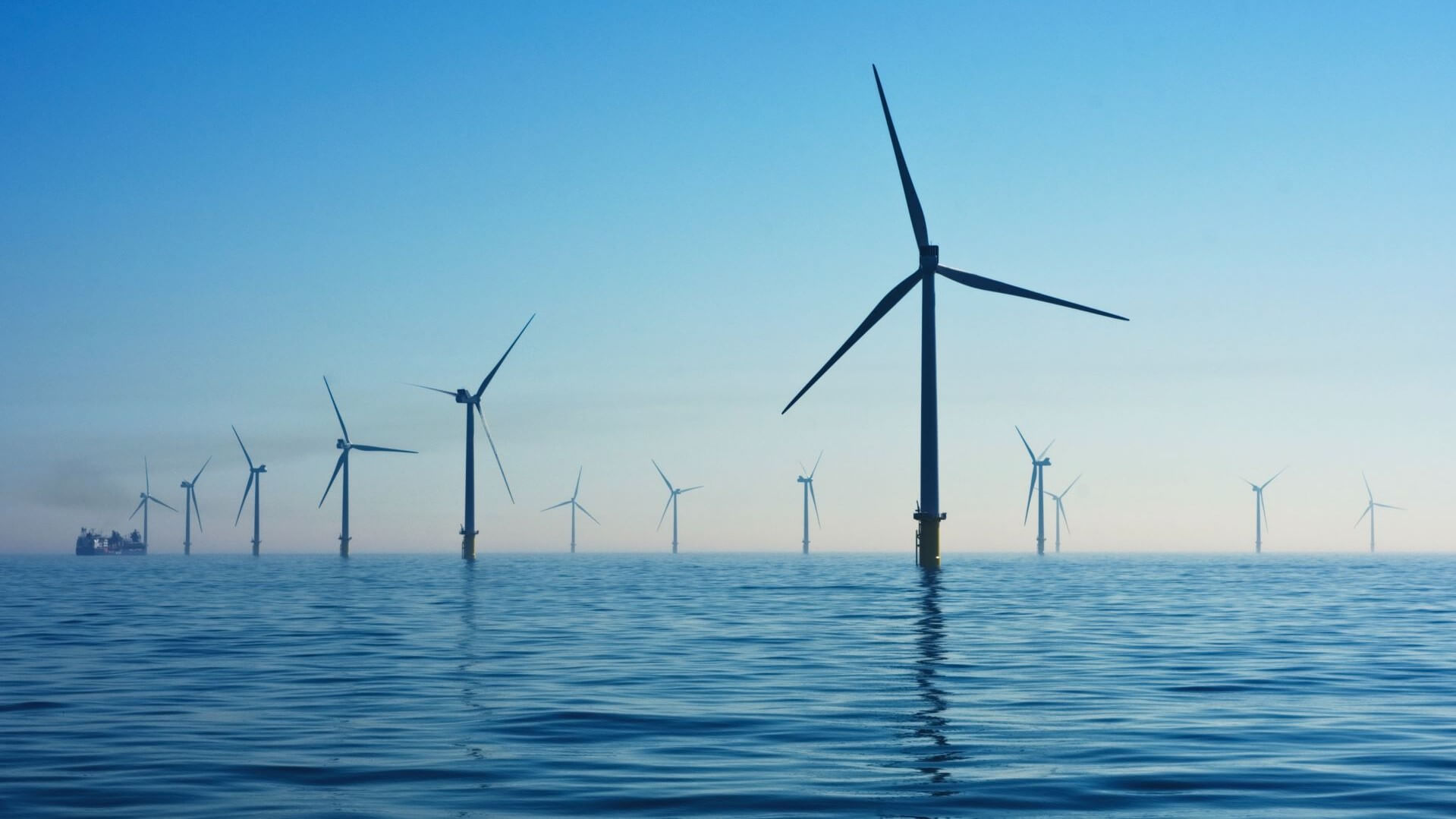 Floating offshore wind farm in blue sea set against blue sky
