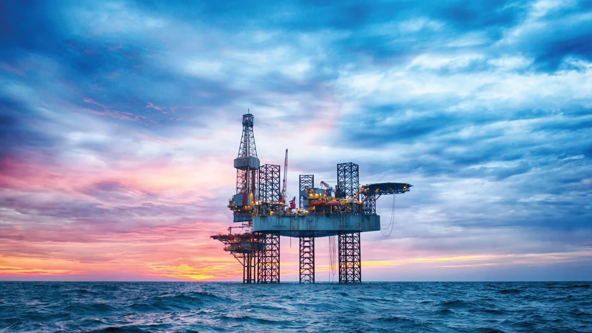 Offshore oil platform at sunset