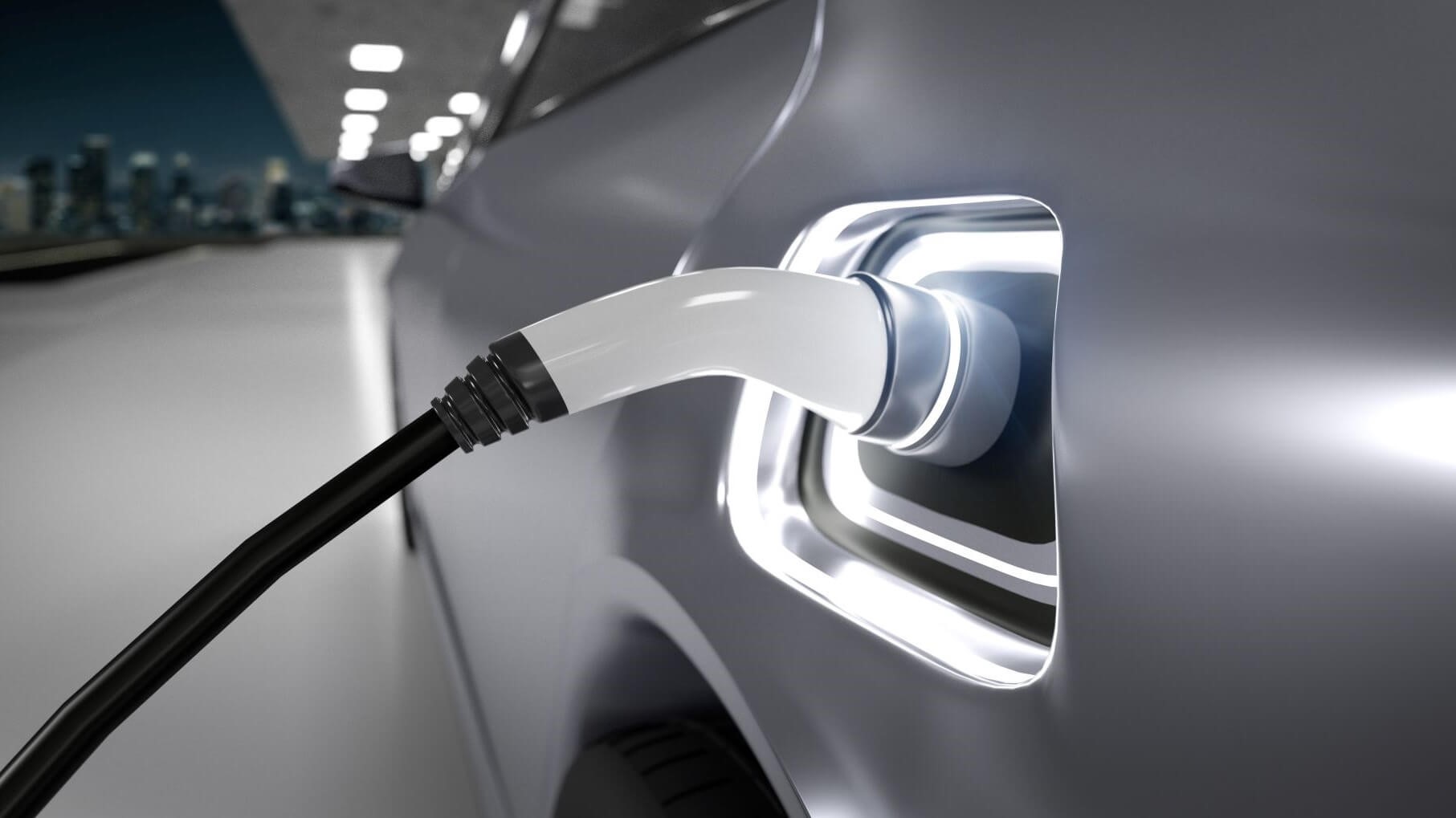 Close up of electric vehicle plugged in to charger