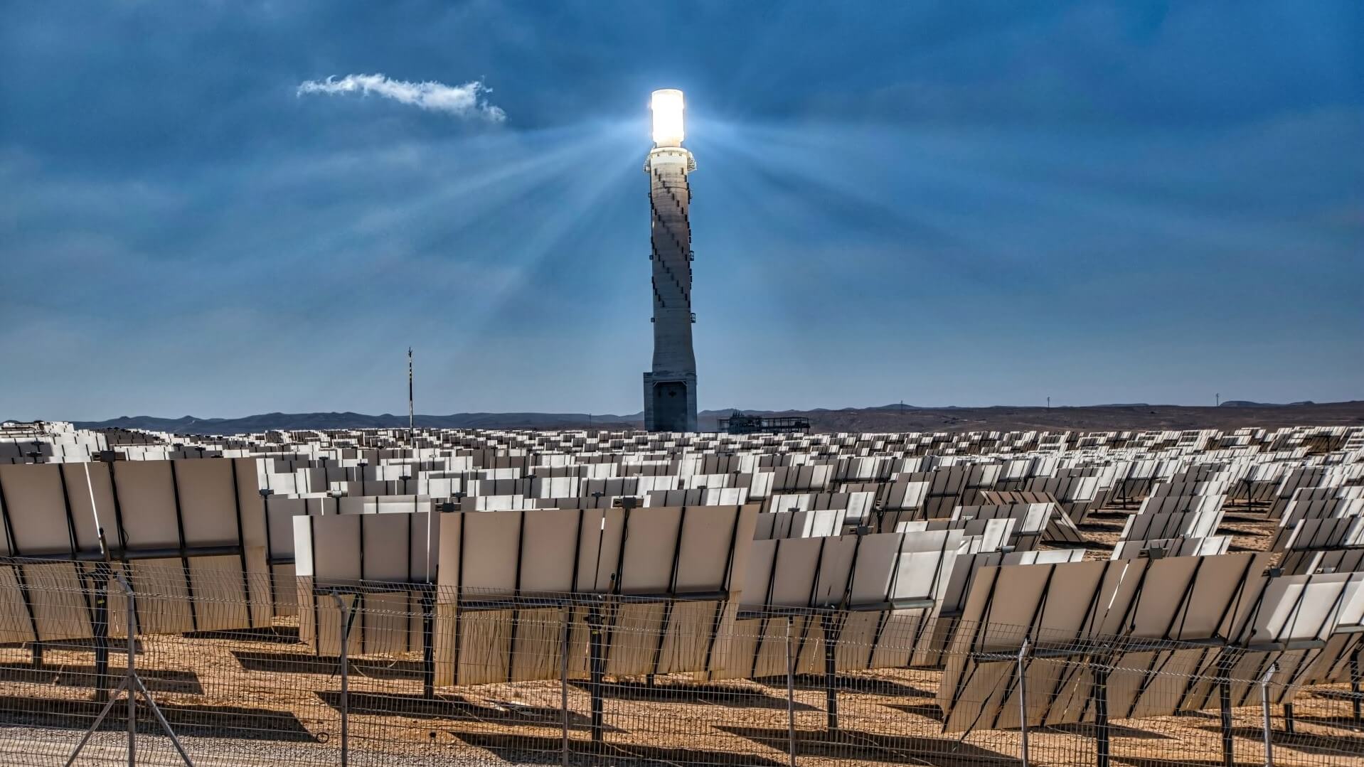 Solar panels facing towards central receiver in concentrated solar farm