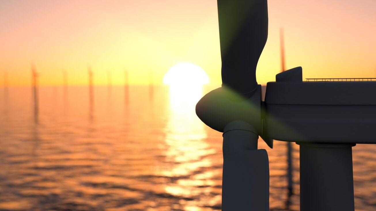 Close up of one offshore wind turbine at sunset, others in background