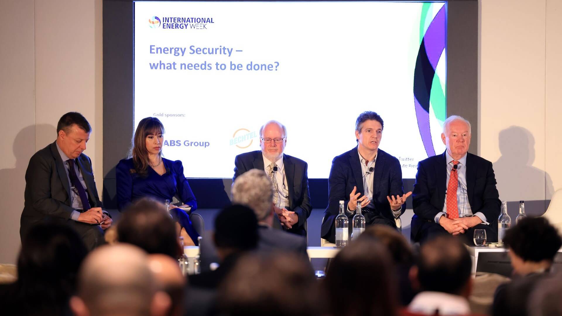 Five panellists sat on International Energy Week stage with screen behind them