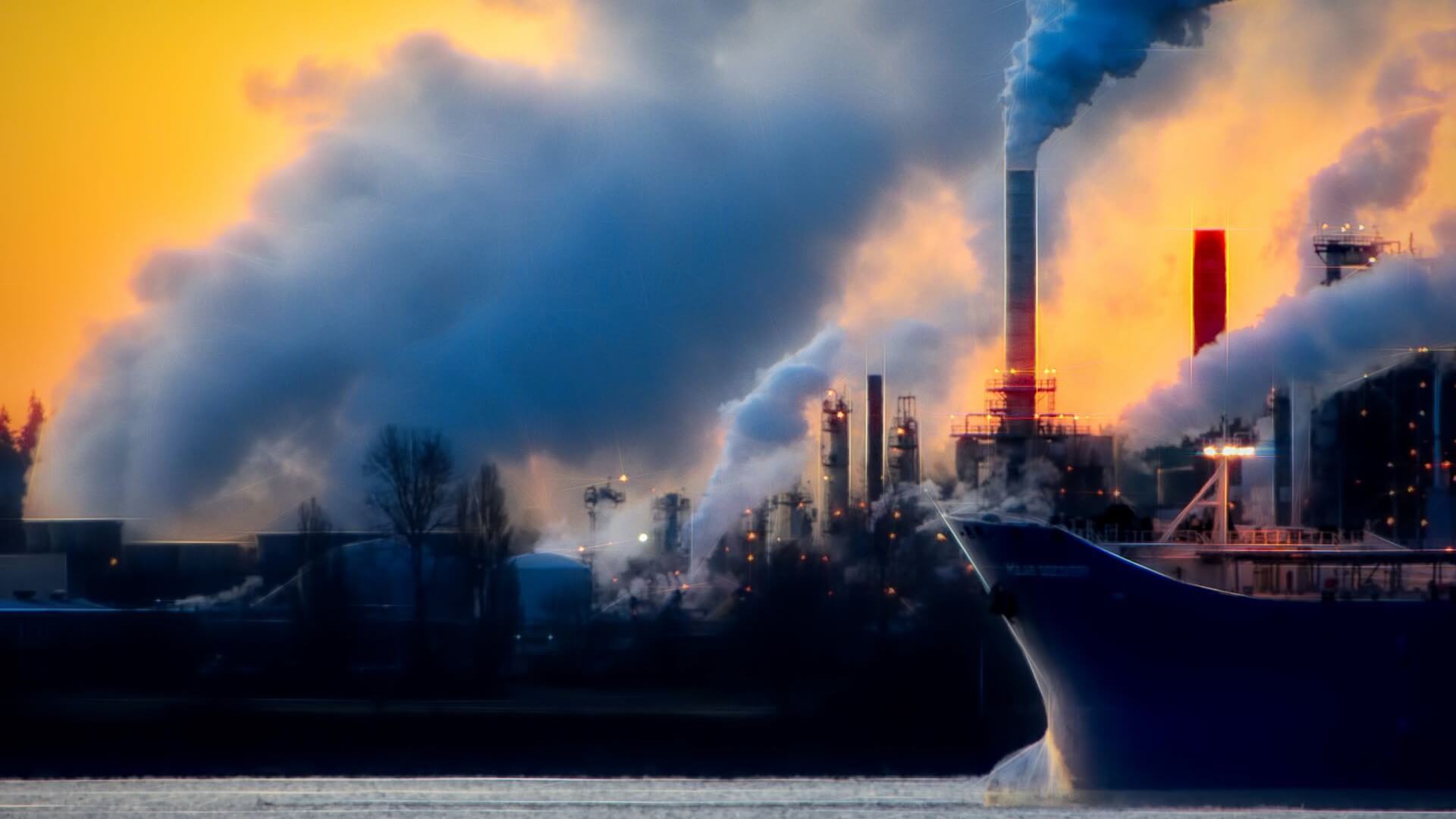 Clouds of smoke being emitted from industrial scene