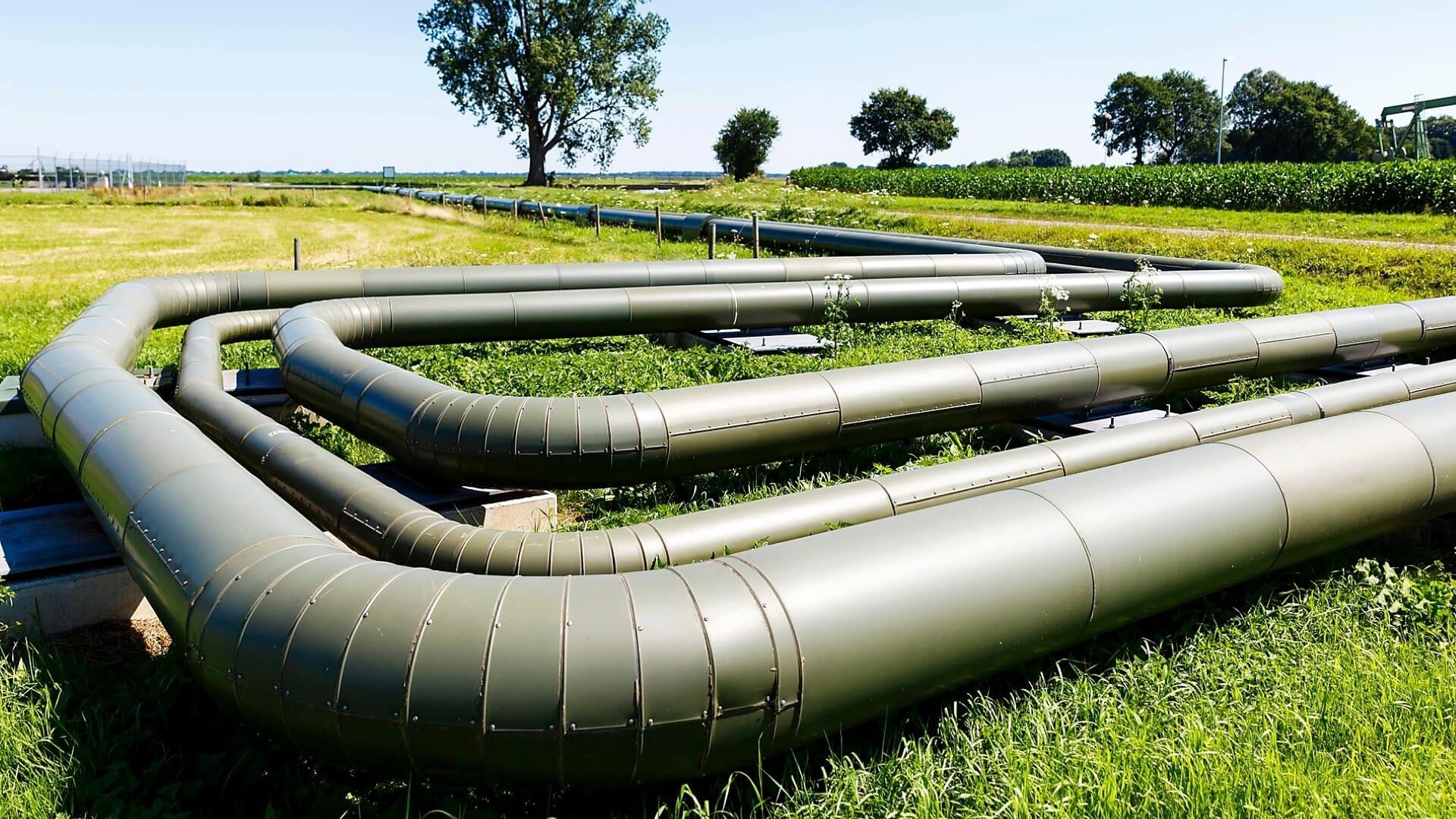 Loop of gas pipelines crossing grassy field