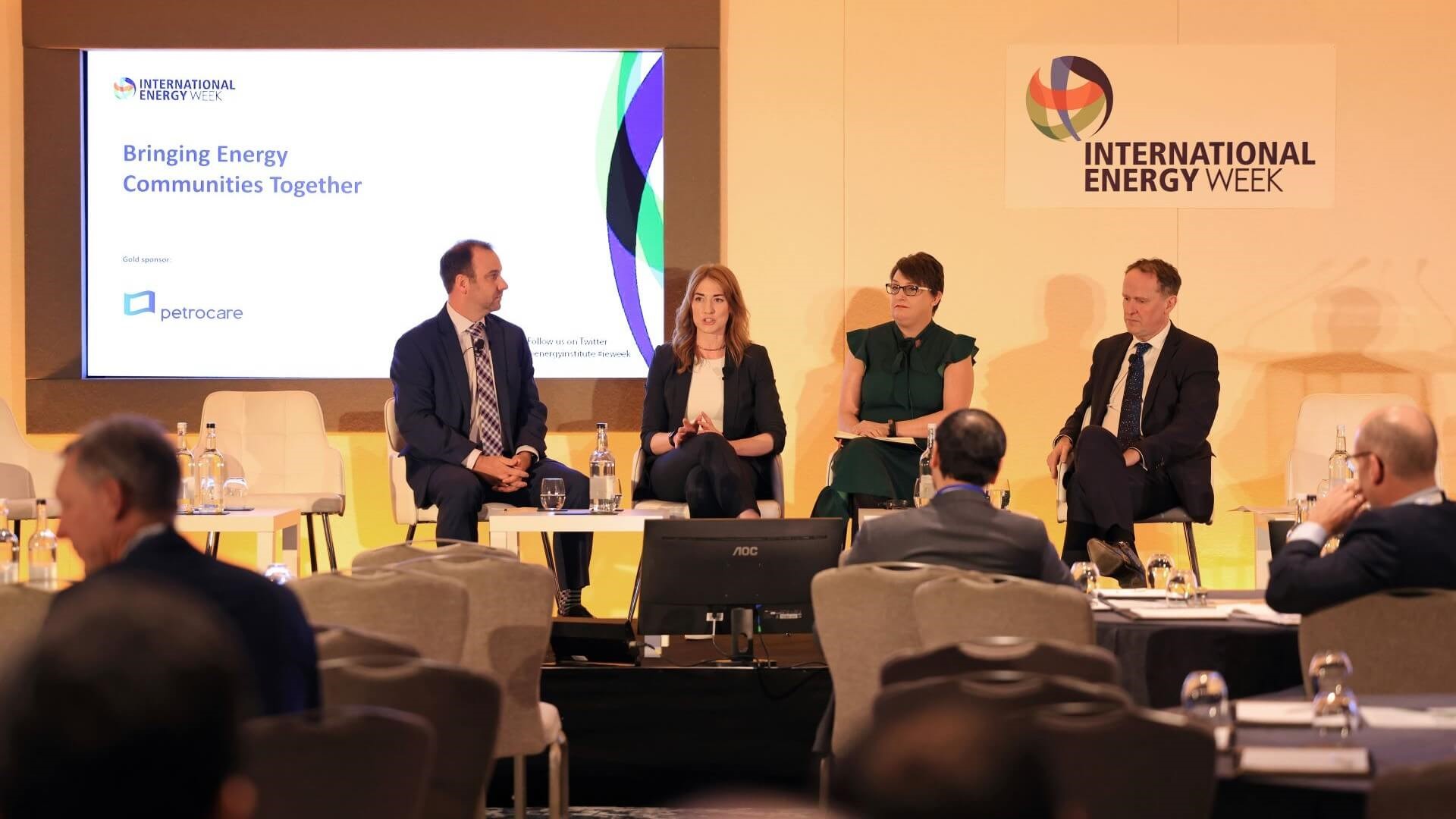 Panel of four speakers sitting on stage at International Energy Week 2023