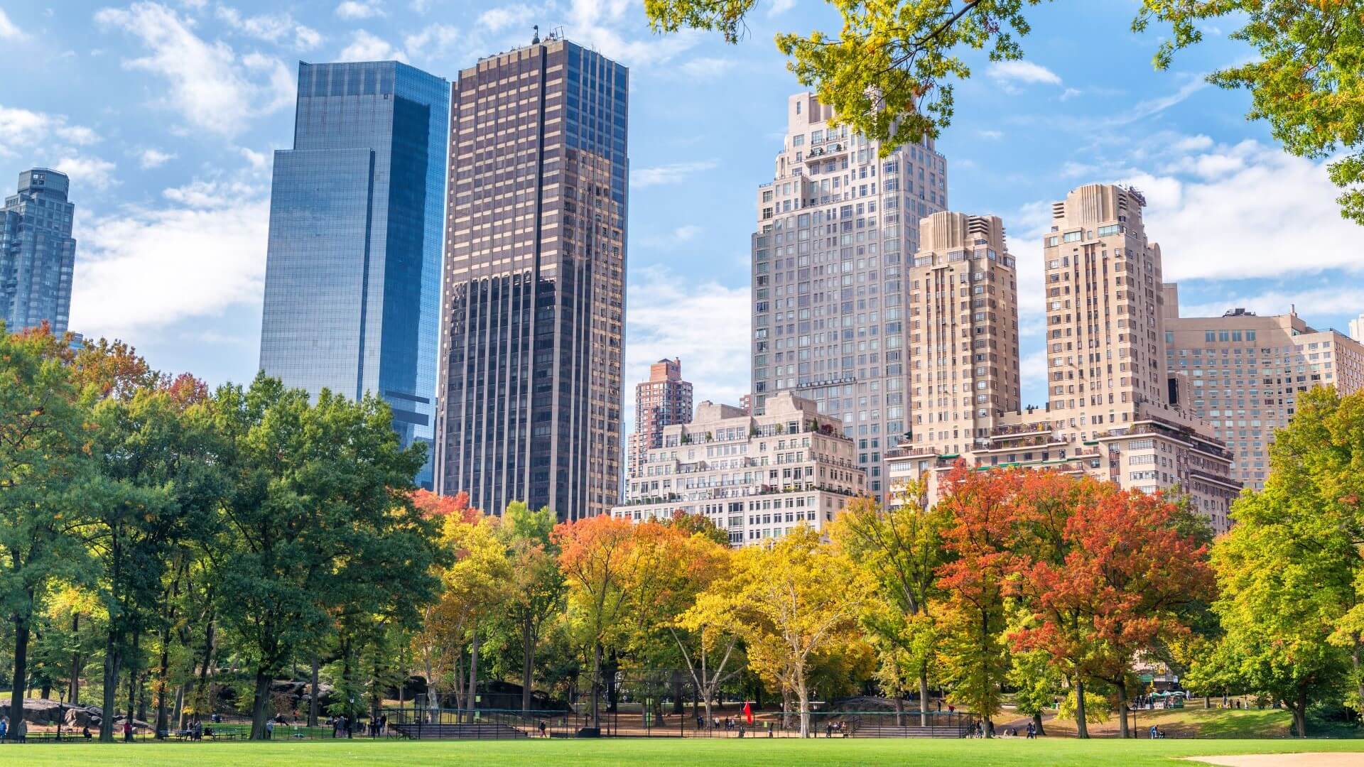 Skyscraper buildings in New York City with autumnal trees of Central Park in foreground