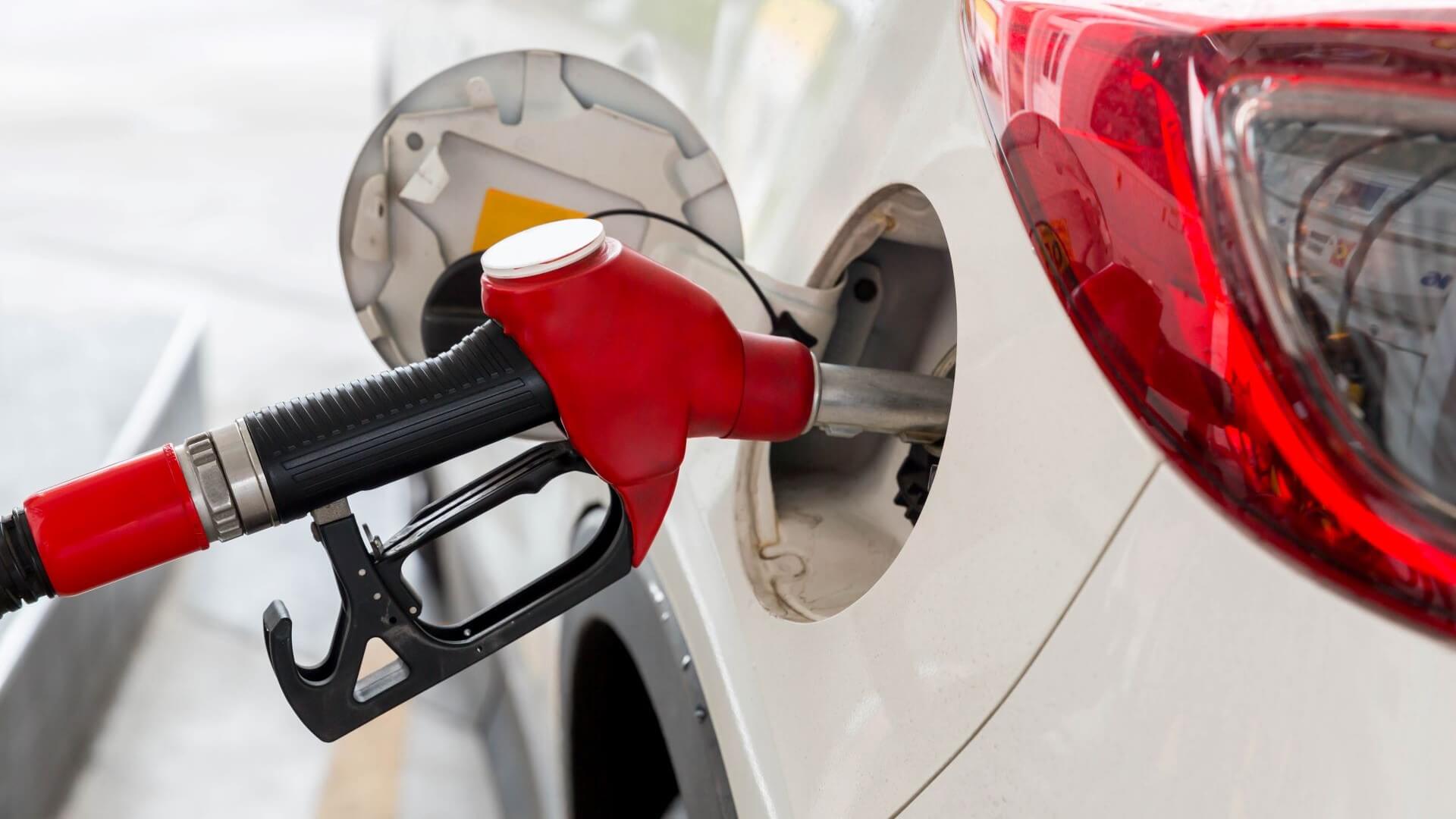 Close up of refuelling nozzle refuelling car