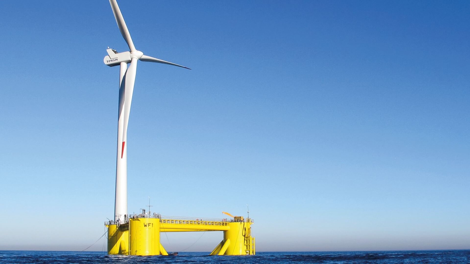 Floating offshore wind farm in blue sea set against blue sky