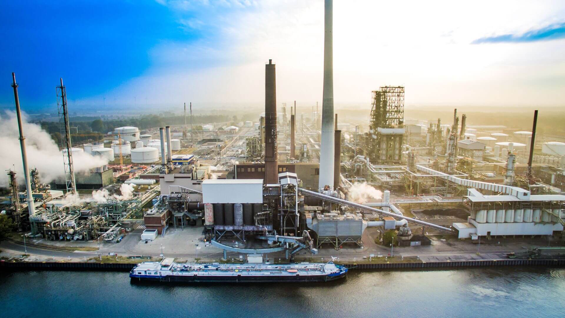 Aerial view of refinery with tanker in foreground