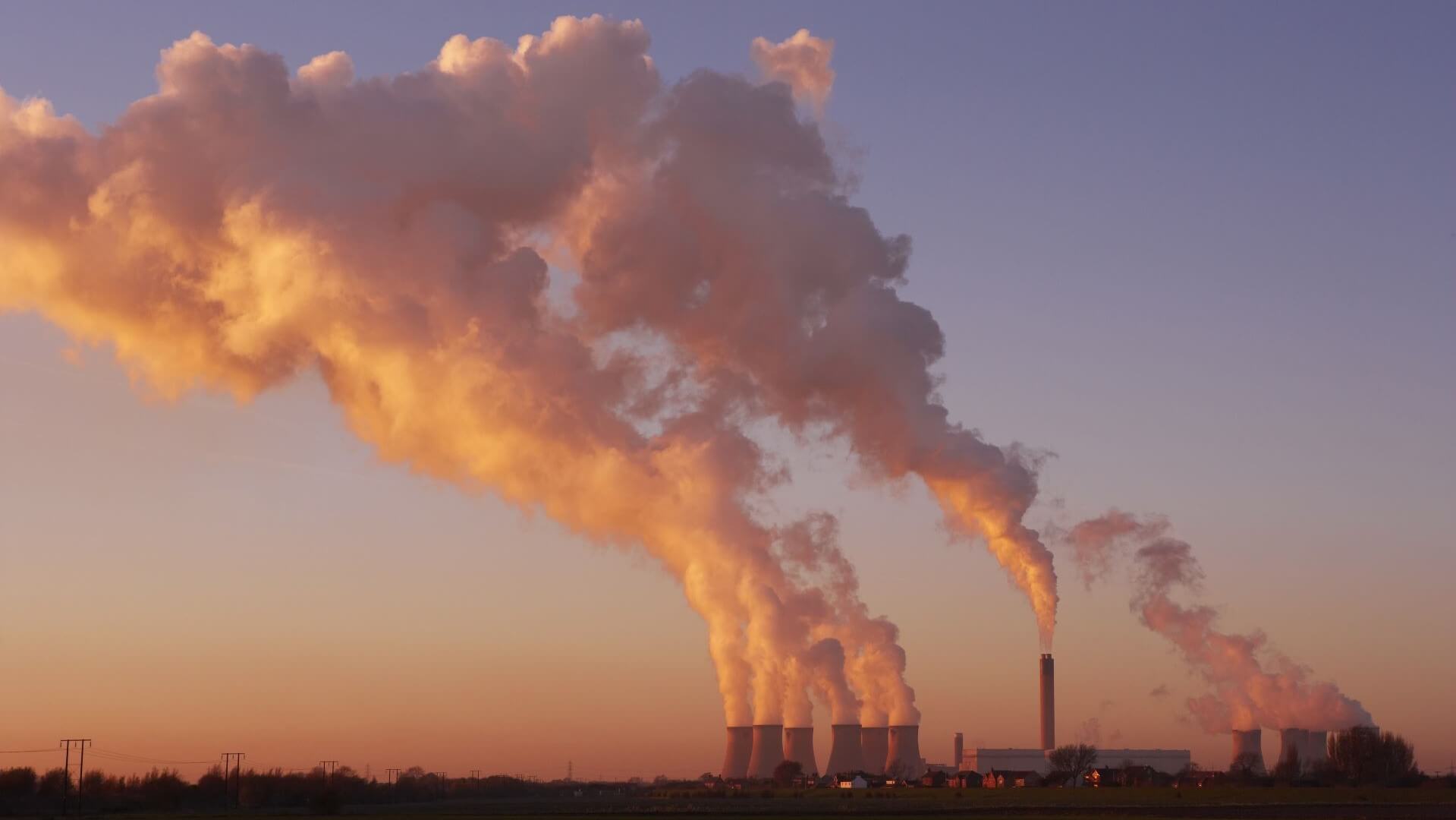 View of smoke emissions from Drax power station against darkening sky