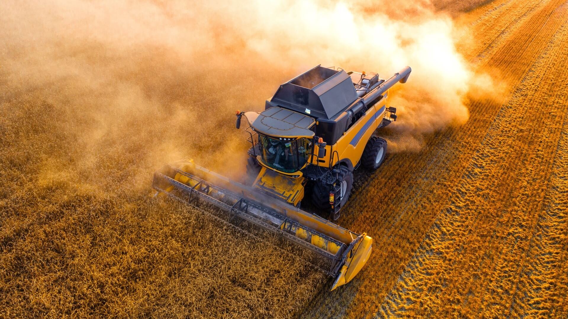 Aerial view of vehicle harvesting wheat in field