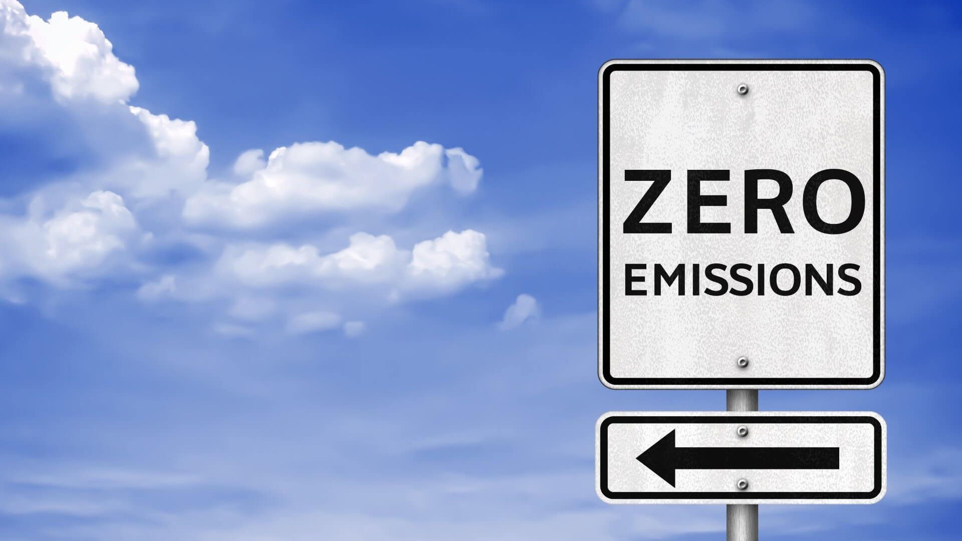 Net zero sign post against blue sky