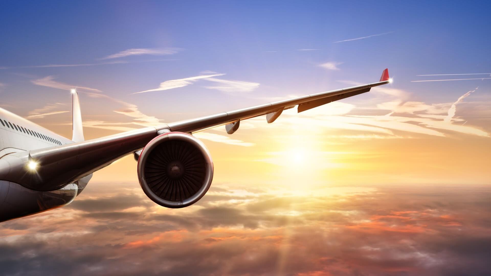 Aircraft wing flying above clouds