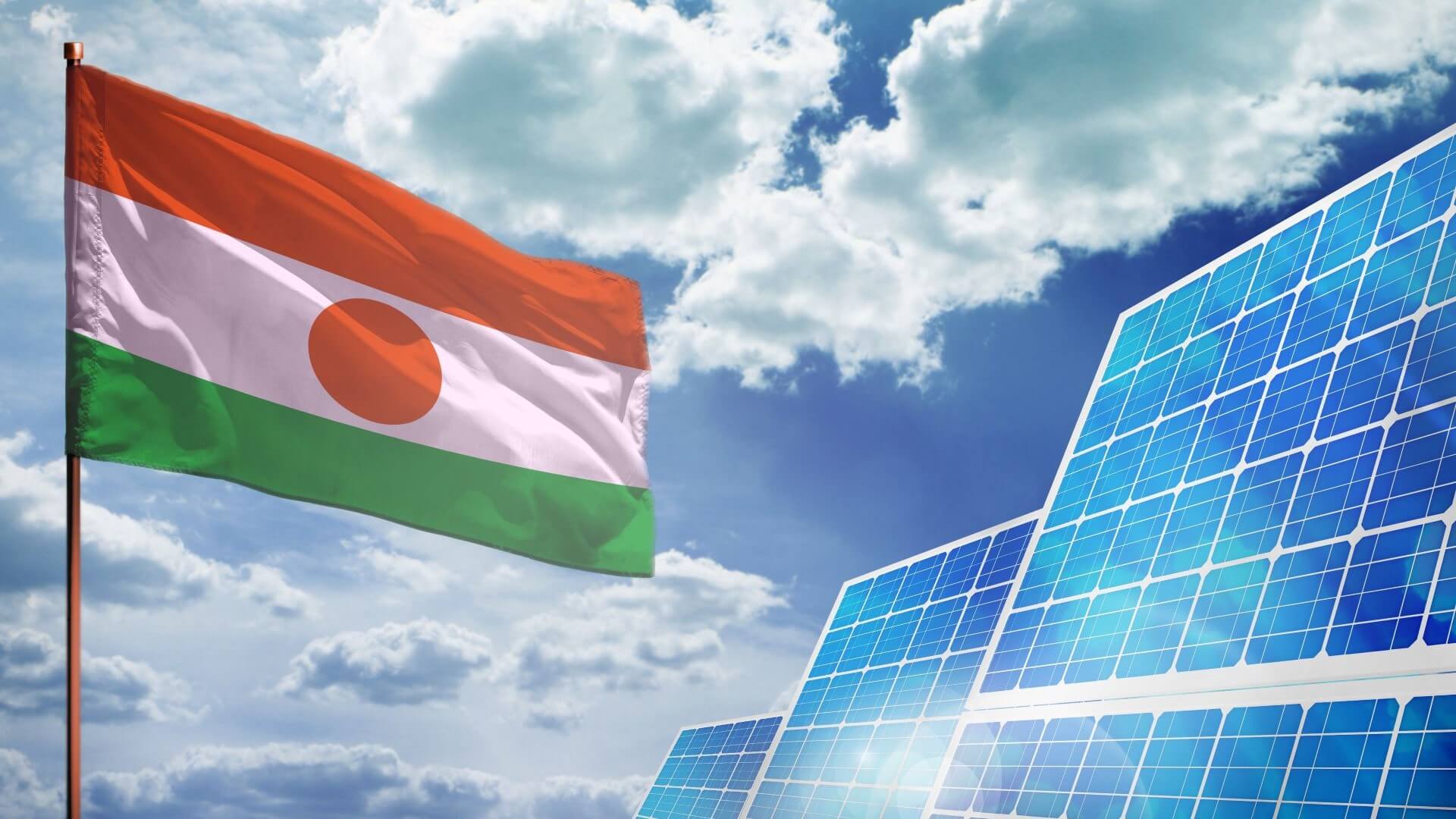 Niger flag and solar panel against blue sky