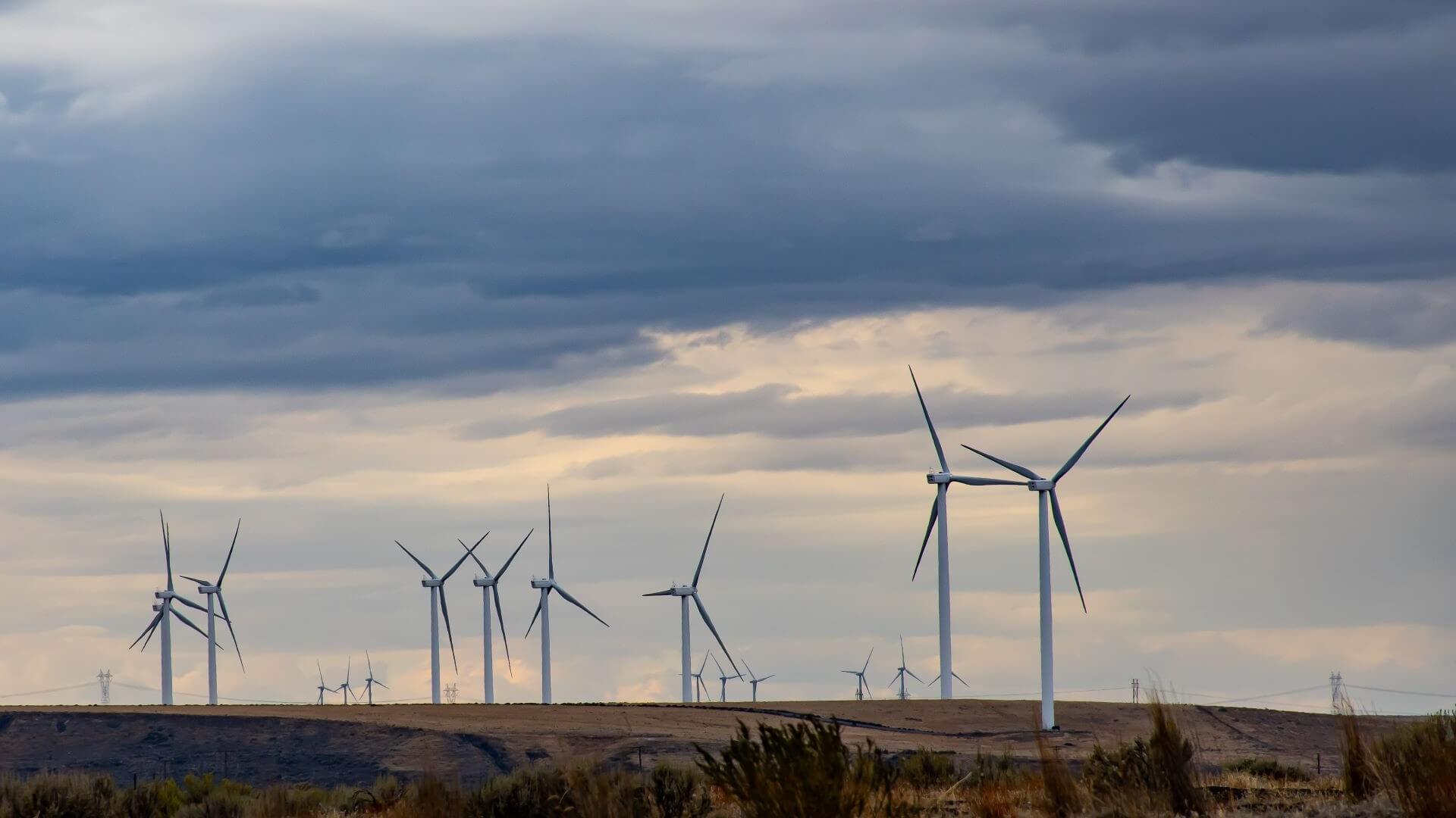 Onshore wind farm set against grey and cloudy sky