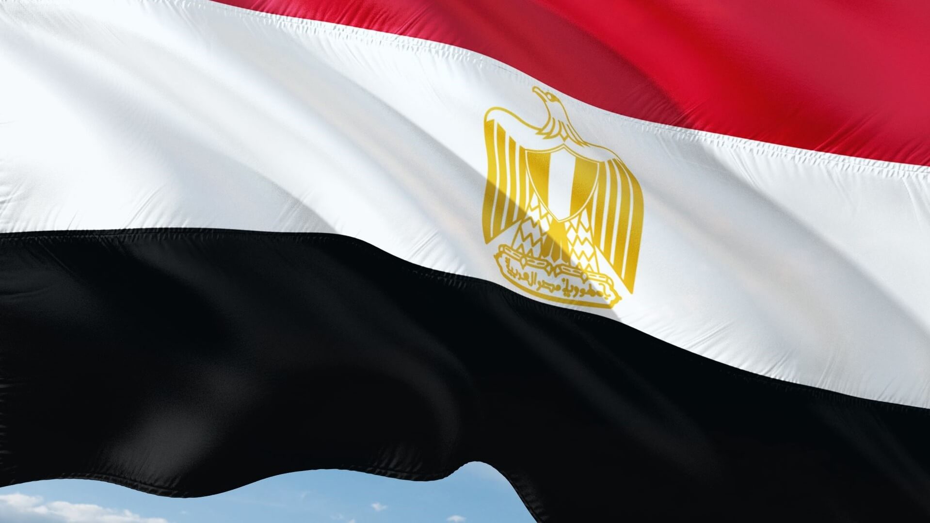 Egyptian flag flying against blue sky