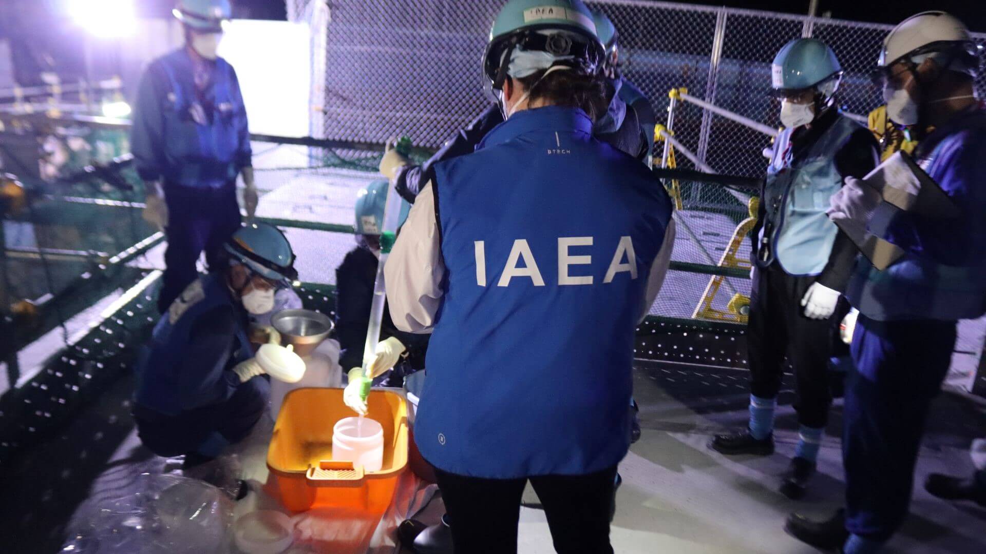 Workers at the Fukushima nuclear plan sampling the treated and diluted waste water