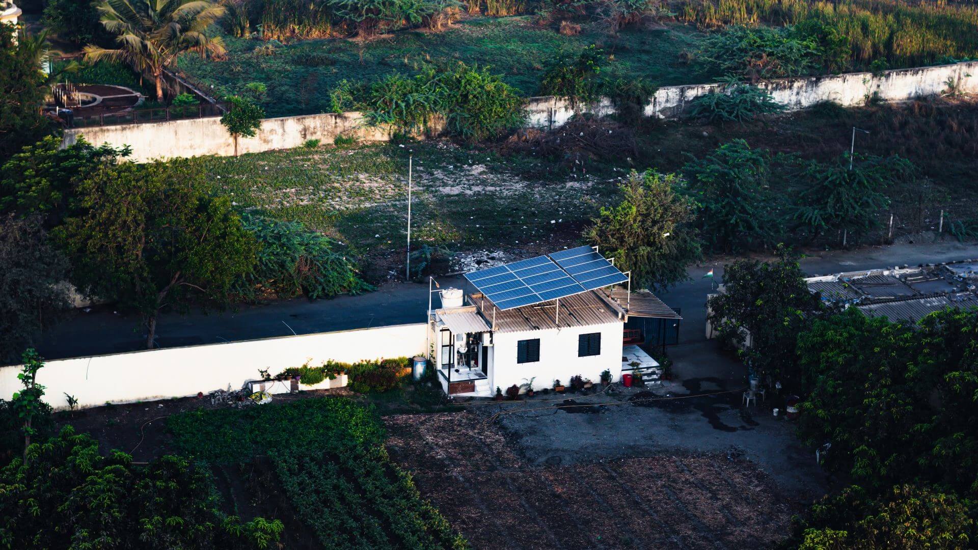 Aerial view of property in India with solar panels on roof