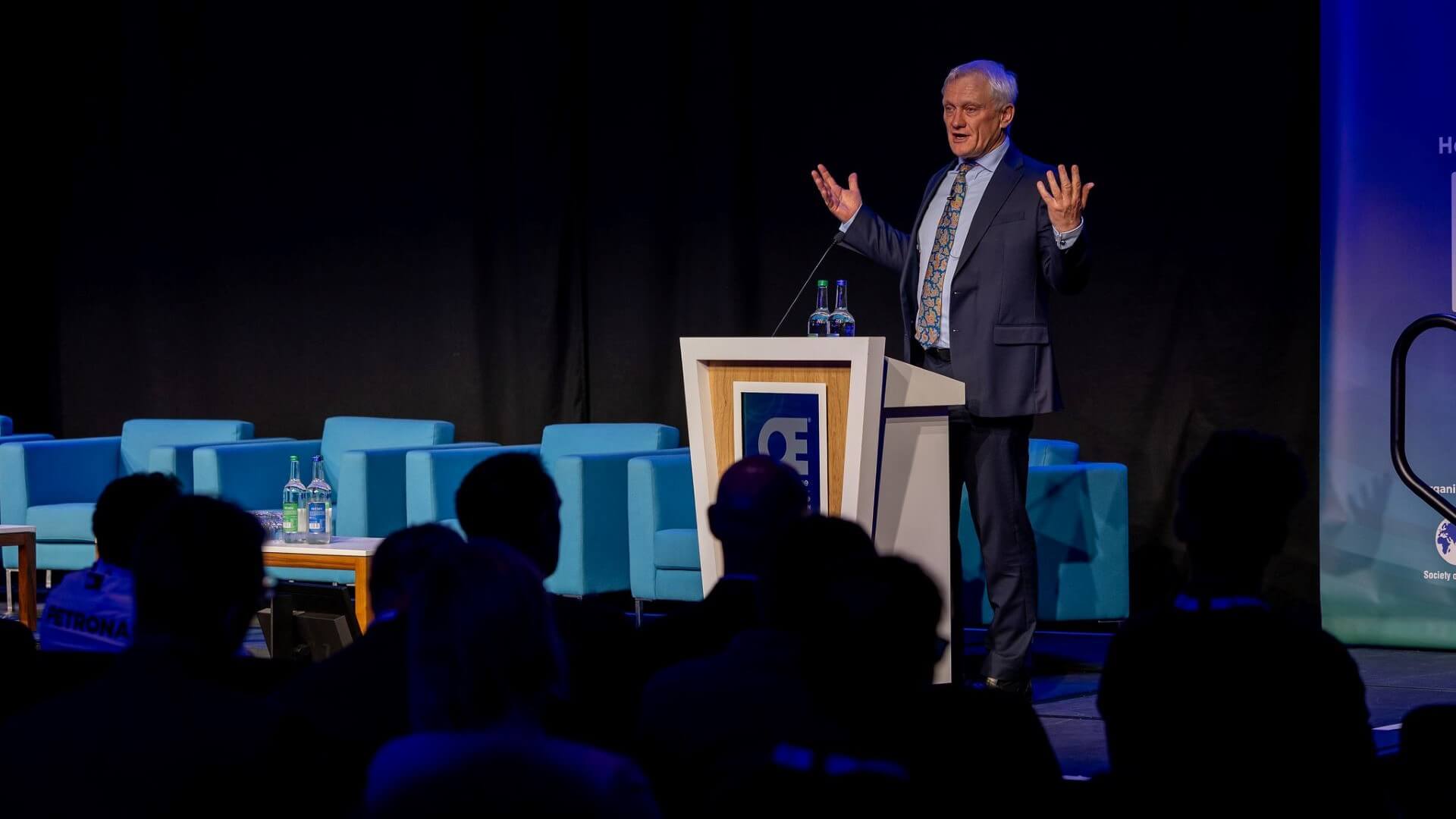 Graham Stuart, UK Minister for Energy Security and Net Zero, on stage talking to delegates