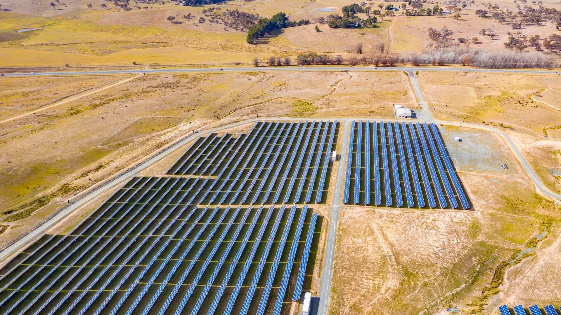 Banks of solar panels set in parched landscape