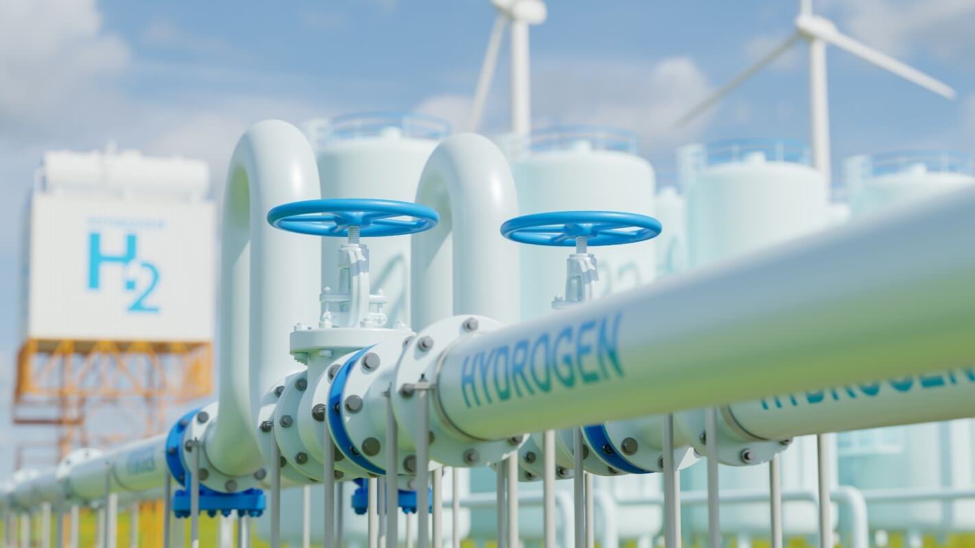Computer generated image of white aboveground pipeline with hydrogen written on it in blue, and wind turbines and battery storage in background