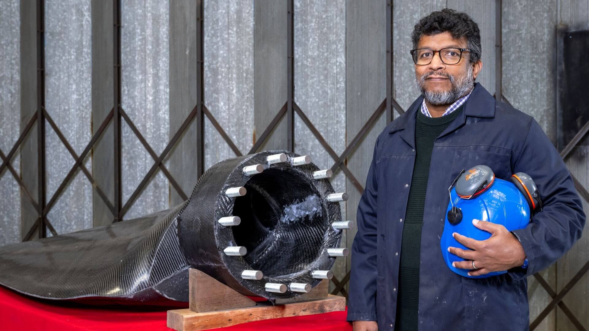 Engineer stood next to the new turbine blade