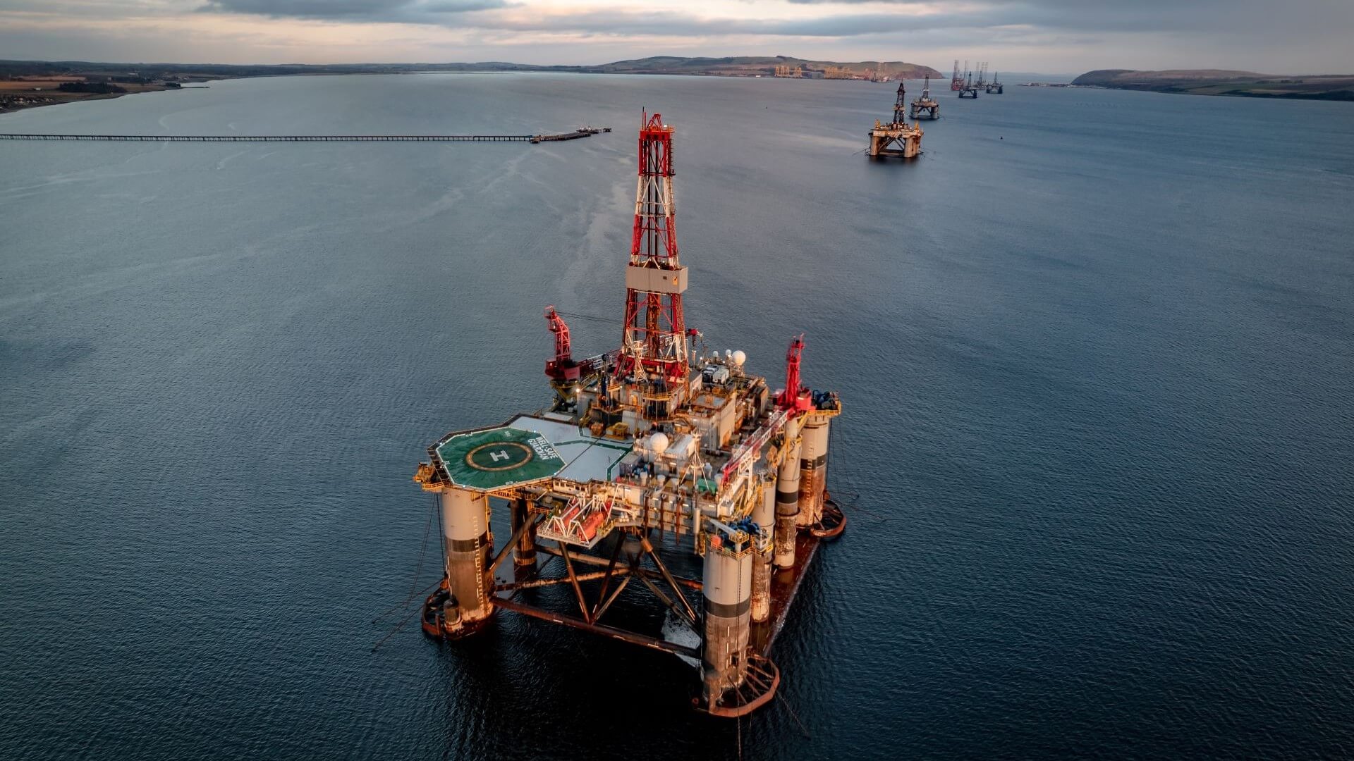 Aerial view of a line of offshore drilling platforms