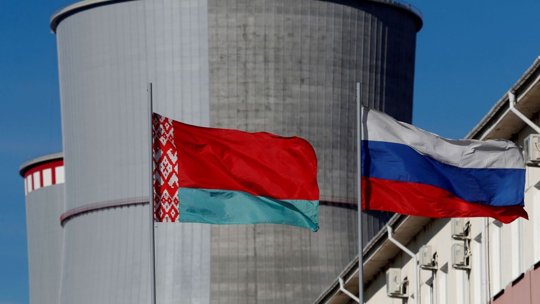 Close up of lags of Belarus and Russia flying outside the nuclear power plant