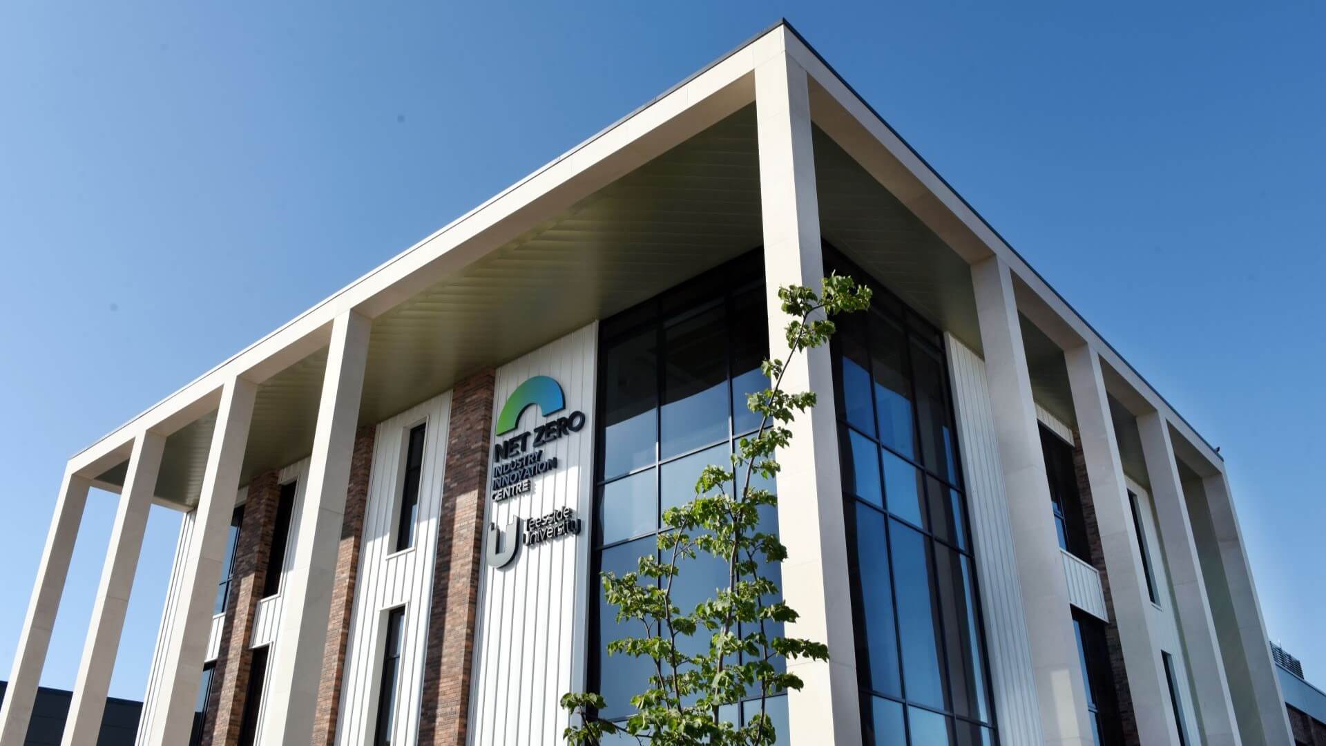 Close up of rectangular Teesside University’s Net Zero Industry Innovation Centre building with tall windows and supporting pillars