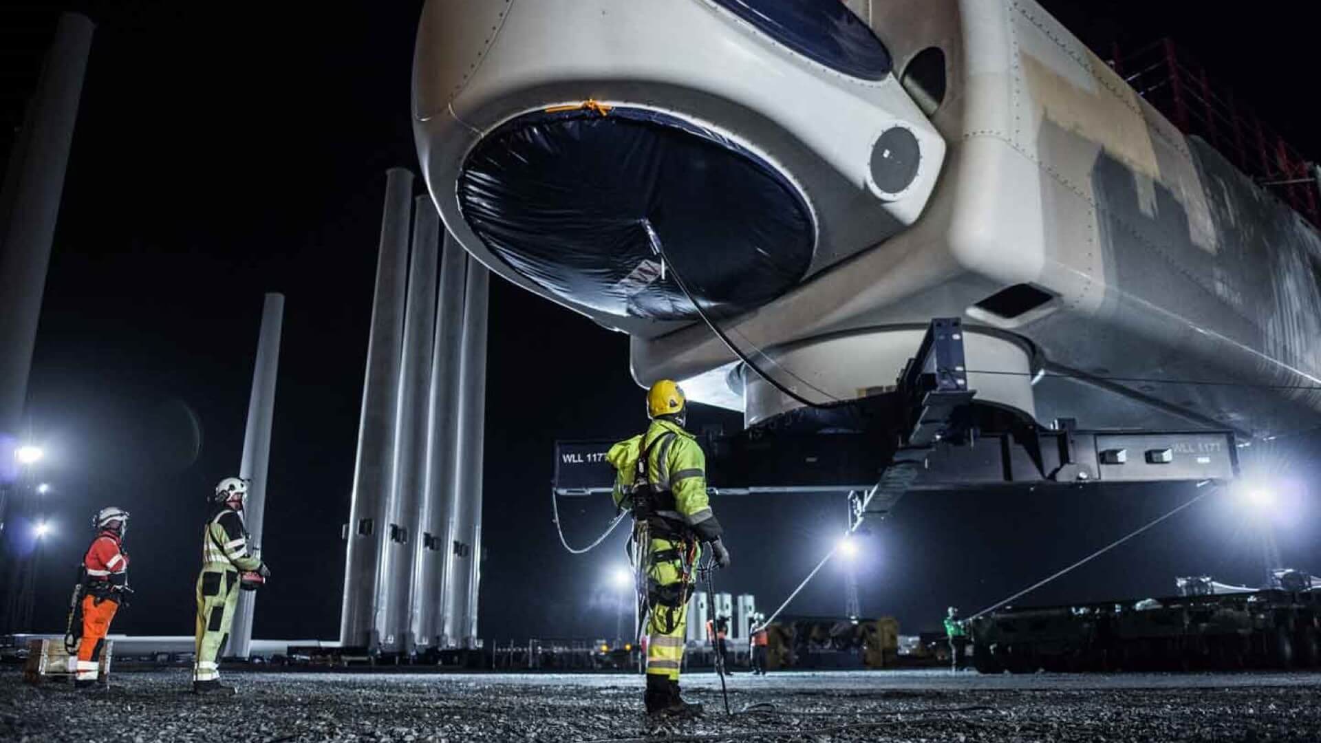 Construction workers with wind turbine nacelle