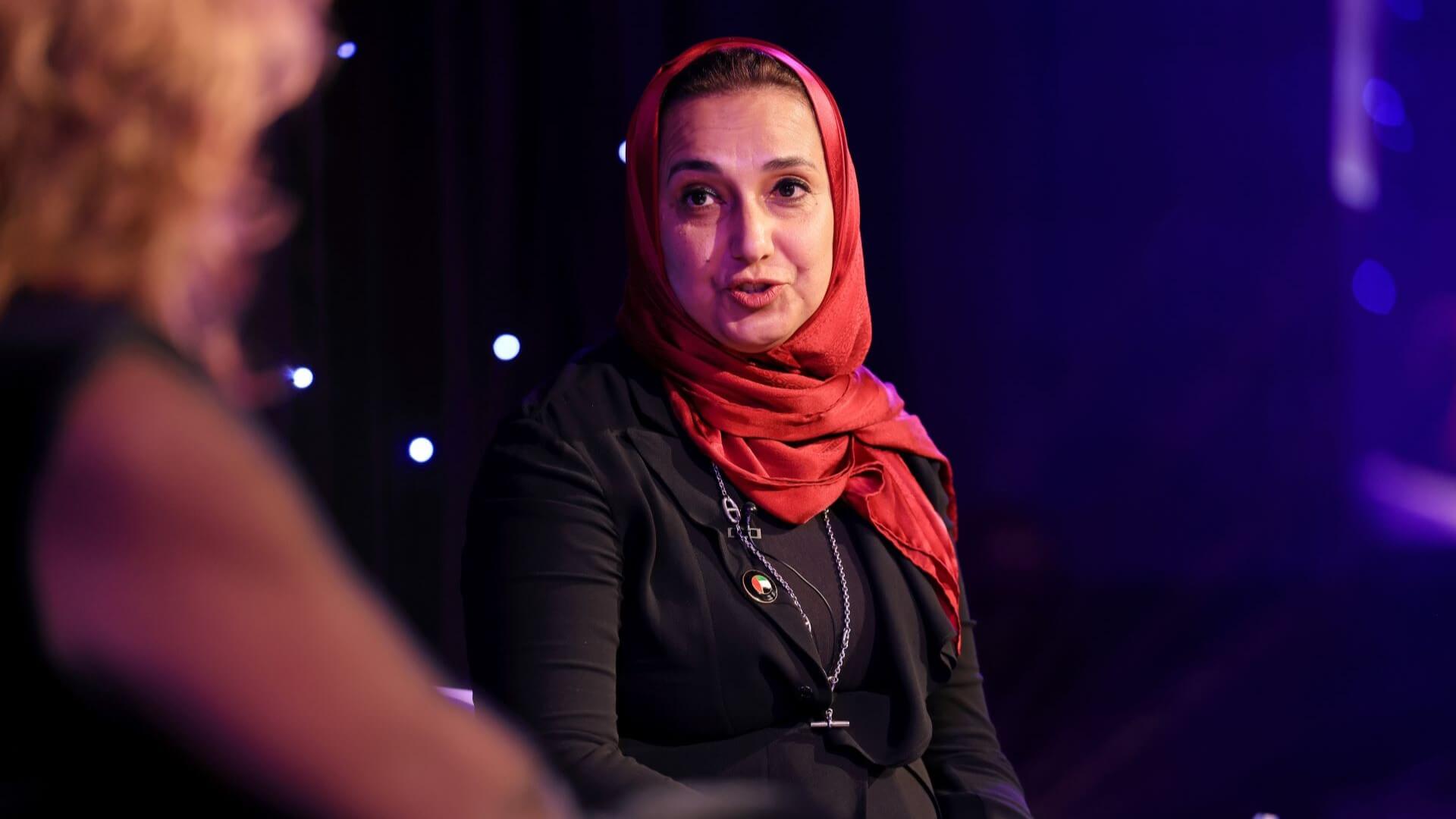 Dr Nawal Al-Hosany sitting on IE Week stage talking to EI President Juliet Davenport 